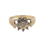 A 9ct gold cluster ring, set with czs in illusion setting, with raised mount, on star etched borders