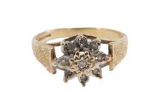 A 9ct gold cluster ring, set with czs in illusion setting, with raised mount, on star etched borders