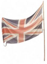 A 20thC Union Jack flag, on bamboo pole, 240cm high. (AF)