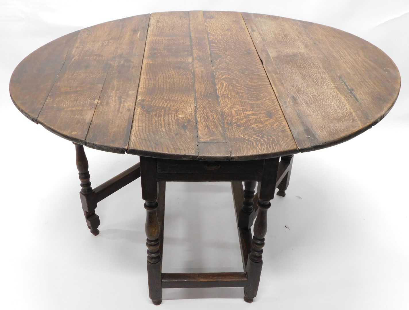 An 18thC oak oval gate leg table, on turned supports, 109cm wide. (AF) - Image 3 of 3