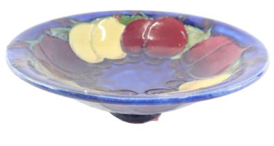 A Moorcroft miniature comport, in the Fruit Blossoms pattern, on a blue ground, 13cm diameter.