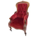 A Victorian walnut spoon back show frame armchair, with red upholstered button back and arms, padded