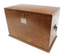 An Edwardian oak writing box, the hinged lid front revealing pigeon holes, inkwells, and a writing s