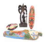 A quantity of tribal items, to include two polychrome coloured masks, a coconut, and a wall carving.