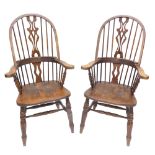 A pair of beech Windsor chairs, each with a pierced splat, solid seat, on turned legs with double H