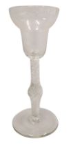 An 18thC wine glass, with a bell shaped bowl, air twist knopped stem and plain doomed foot, 15cm hig