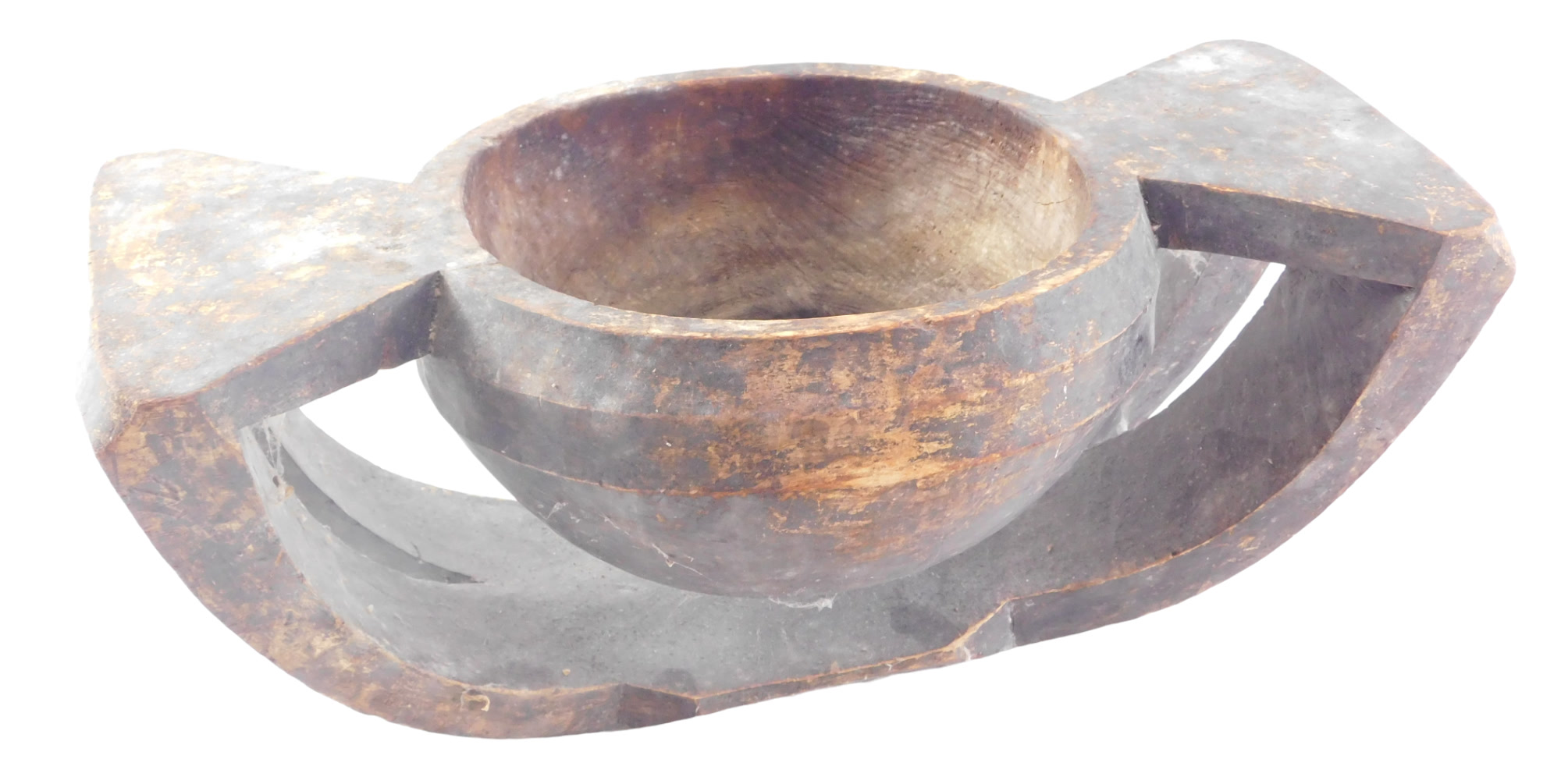 Tribal Art. An African carved wooden bowl, on arched support, 42cm wide.