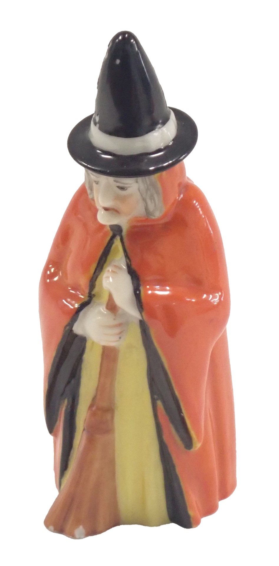 A Royal Worcester candle snuffer, modelled as a witch in red overcoat, 10cm high.