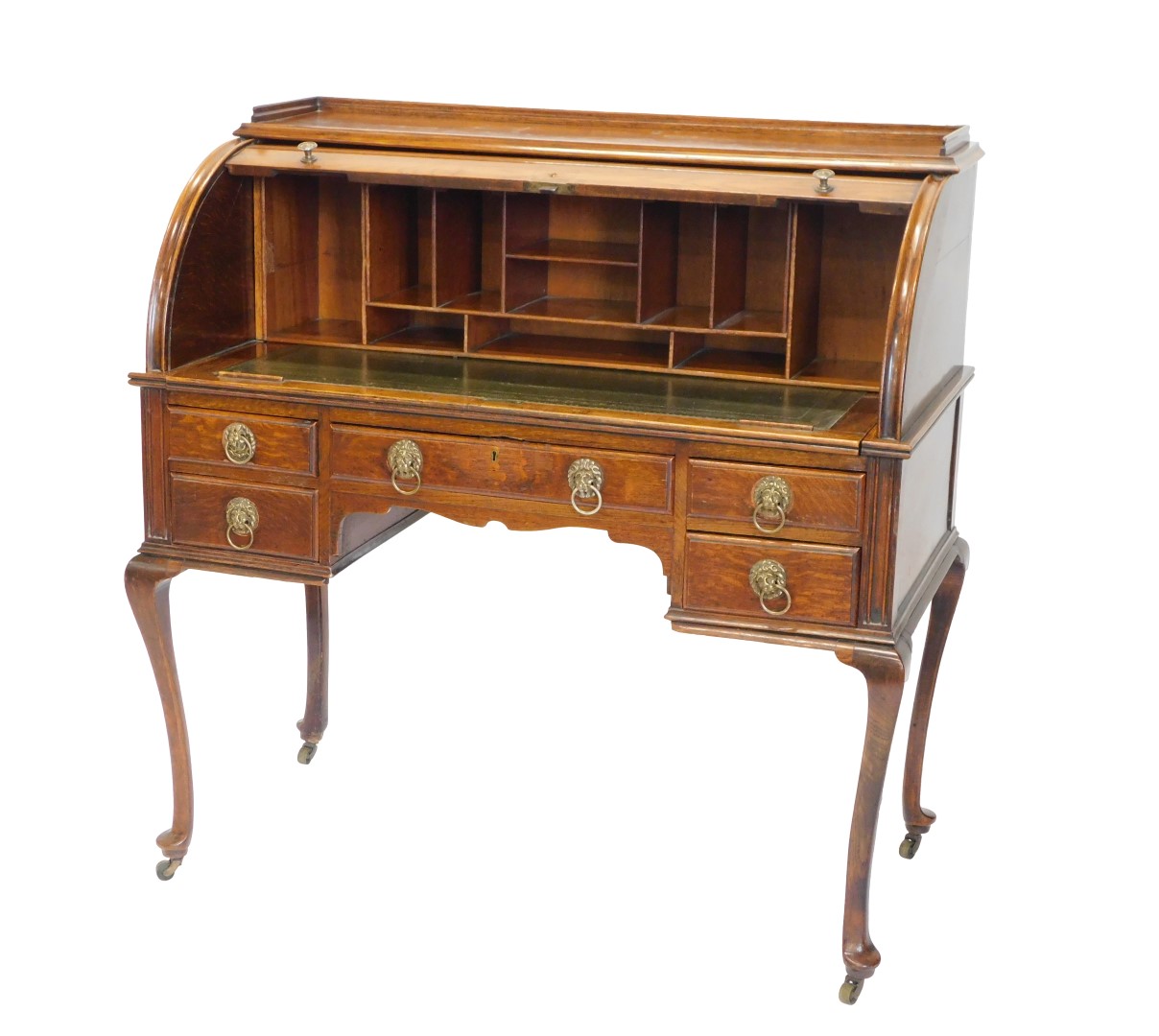 A early to mid 20thC oak roll top desk, with a raised gallery, above a tambour, enclosing fitted int