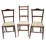 A pair of Edwardian nursing chairs, each upholstered in cream fabric and another chair. (3)
