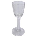 An 18thC wine glass, the bell shaped bowl engraved with grapes and vines, with an opaque twist stem