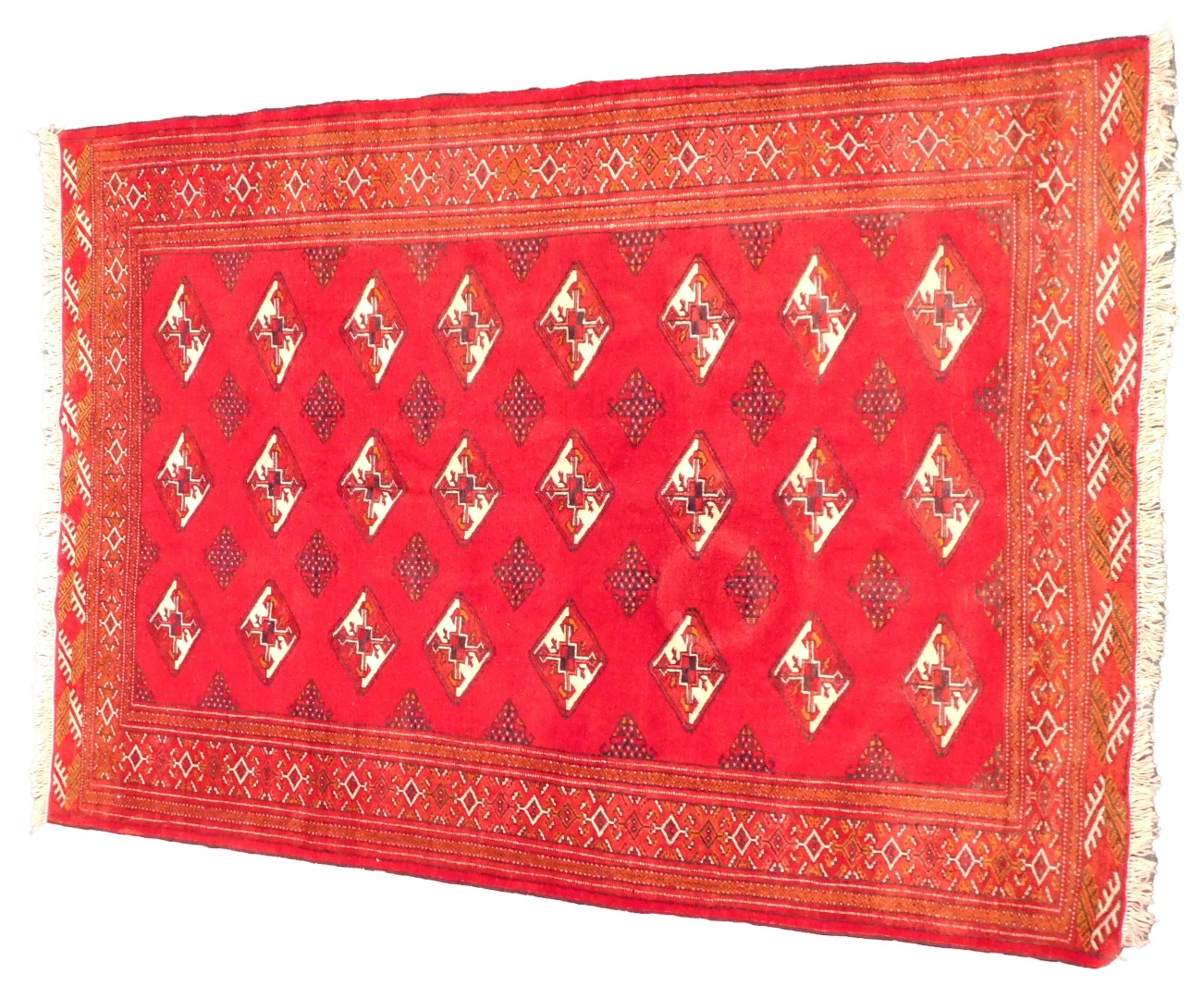 A Turkoman rug, with a design of lozenges on a red ground, 106cm x 198cm.