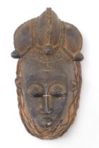 Tribal Art. Baule/Baoule tribe, Mblo classic portrait mask with very elaborate coiffure, encrusted p