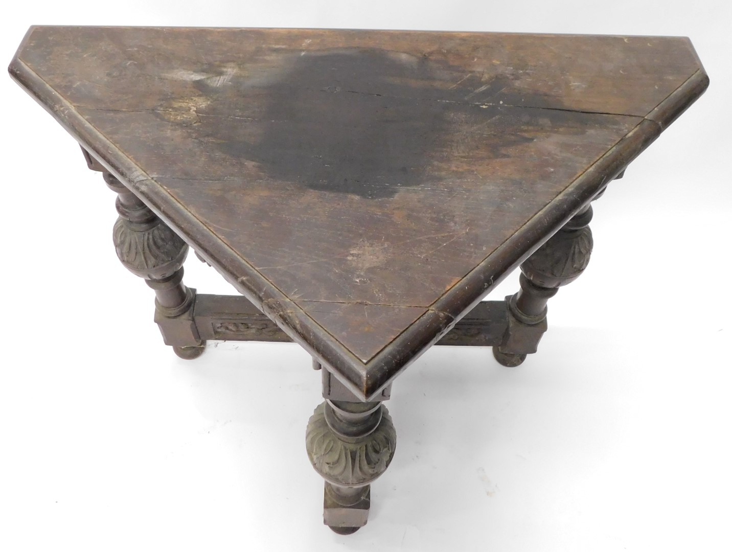 A carved oak triangular side table, the frieze decorated with scrolls, on cup and cover leaf carved - Image 2 of 2