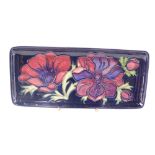 A Moorcroft Anemone pattern pen tray, with green Moorcroft stamp, numbered 34/94, 20cm diameter.