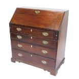 A George III oak bureau, the fall enclosing a fitted interior above four graduated drawers with oval