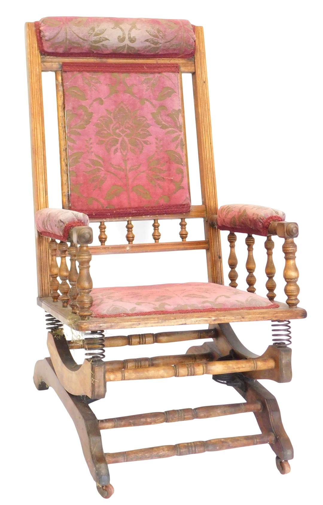 A late 19thC American walnut rocking chair, with a padded back, arm rest and seat, with turned stret