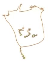 A suite of 9ct gold and peridot set jewellery, comprising a three drop pendant, 2cm high, on fine li