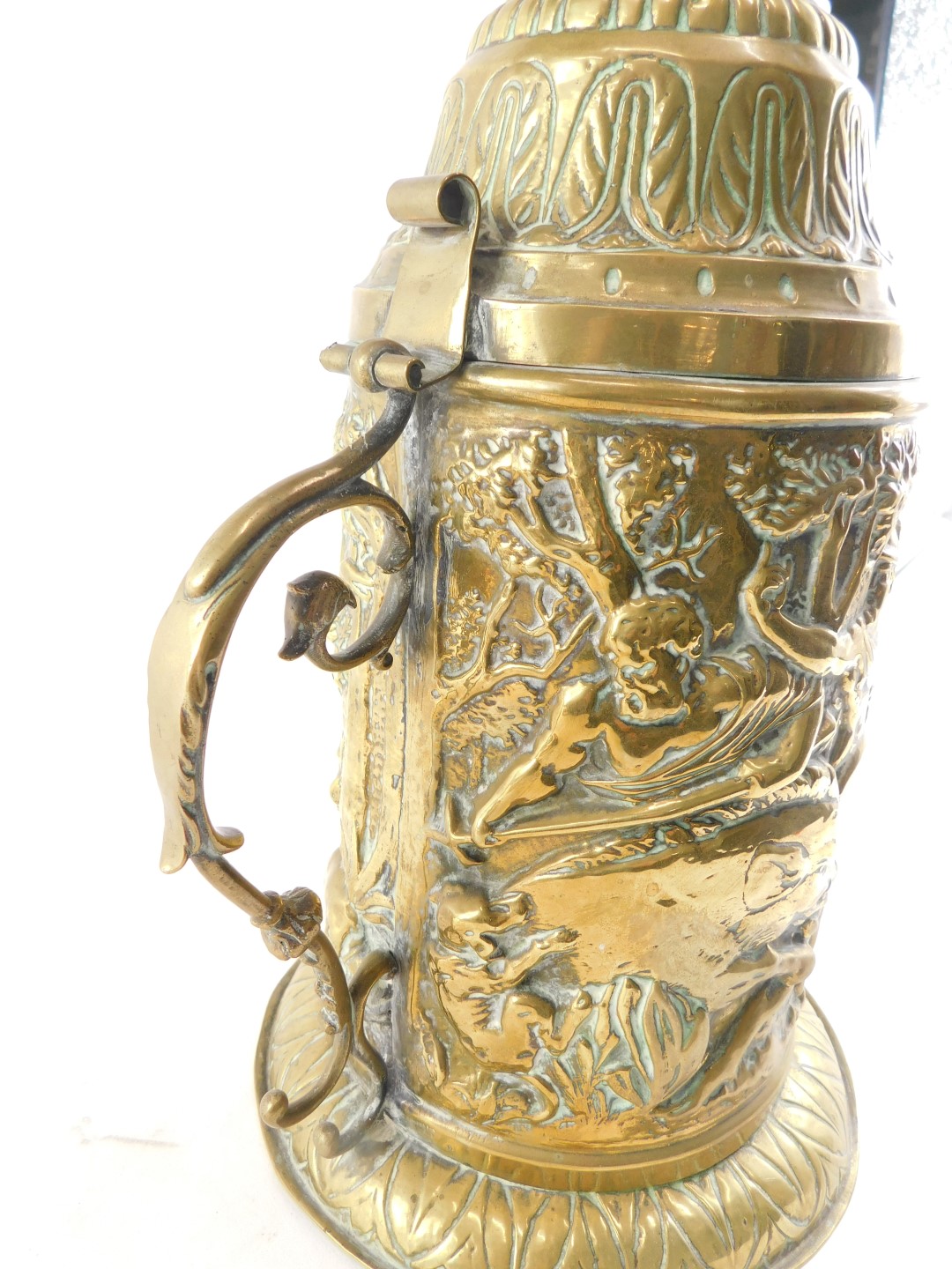 A 19thC continental embossed brass lidded tankard, decorated with figures boar hunting, and a scroll - Image 3 of 4