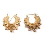 A pair of Eastern style hoop earrings, each with hammered bar and ball design, with arched pin, stam