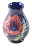 A Moorcroft Anemone pattern bud vase, with green stamp to underside, numbered 34/94 and signed Anji,