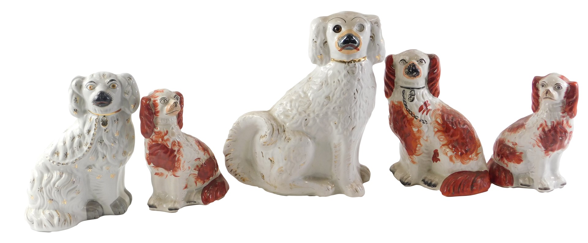 A pair of 19thC Staffordshire spaniels, each with brown decoration, 21.5cm high, and other 19thC Sta