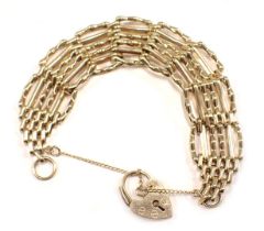 A 9ct gold gate bracelet, of six bar design, with safety chain and padlock, 16cm long, 19.1g.