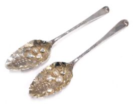 A pair of George III silver berry spoons, the embossed and engraved decoration later, London 1799, 3