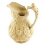 A Victorian beige coloured relief moulded jug, decorated with masks, scrolls, etc., unmarked, 27cm h