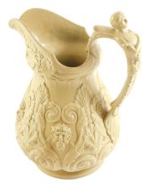 A Victorian beige coloured relief moulded jug, decorated with masks, scrolls, etc., unmarked, 27cm h