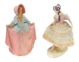 Two early 20thC chalkware figures of ladies, each wearing crinoline style dress, 31cm high.