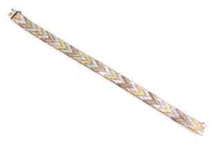 An Eastern inspired tricolour bracelet, set with yellow, rose and white coloured gold, with some pla