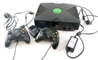 An X-Box games console, with controllers.