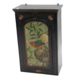 An ebonised Oriental style wall cupboard, with single arched panelled door, painted overall with a d