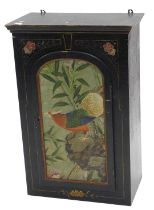 An ebonised Oriental style wall cupboard, with single arched panelled door, painted overall with a d