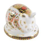 A Royal Crown Derby Piglet paperweight, Imari pattern on oval base with silvered stopper, 5cm high,