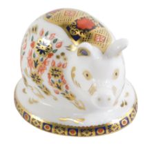 A Royal Crown Derby Piglet paperweight, Imari pattern on oval base with silvered stopper, 5cm high,