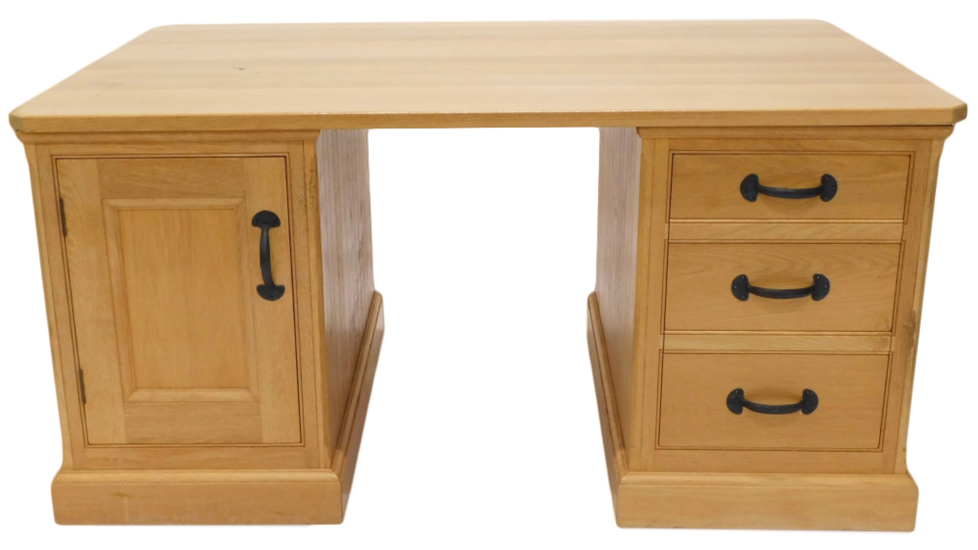 A light oak partner's kneehole desk, rectangular top with canted corners above an arrangement of fal