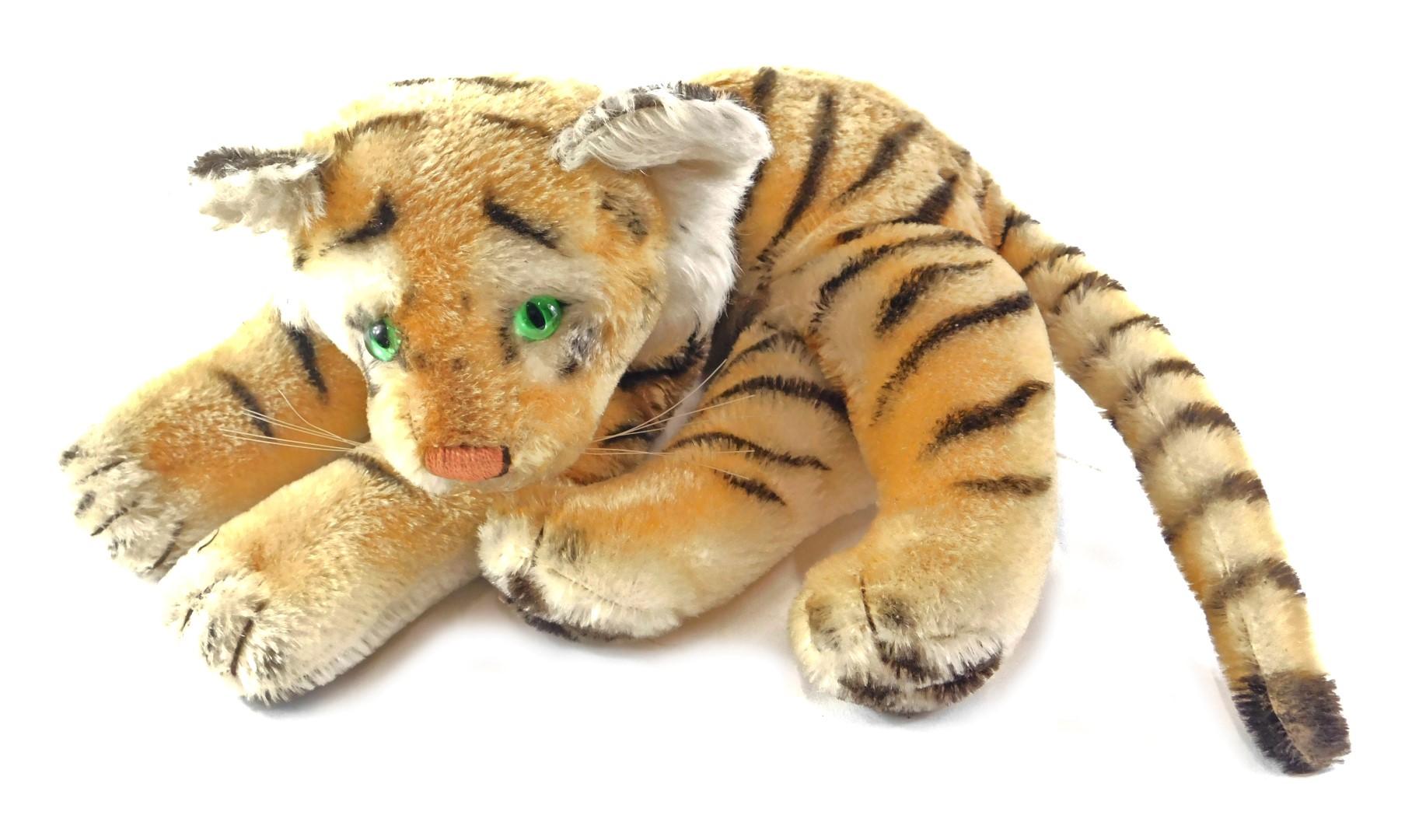 A Steiff plush tiger, 30cm long, ear stud detached.