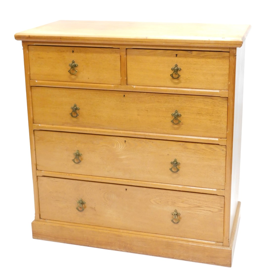 A Victorian ash chest of drawers, the rectangular canted top above an arrangement of two short and t
