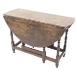 An 18thC oak oval gate leg table, on turned supports, 109cm wide. (AF)