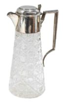 A late Edwardian silver mounted lidded claret jug, of tapered conical facet cut design, the mount an