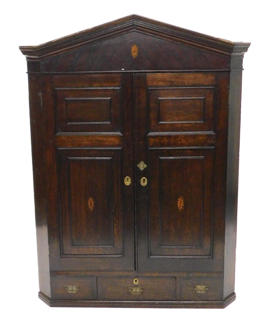 A early 19thC oak and mahogany corner cabinet, the arched cornice above two panelled doors, each lat