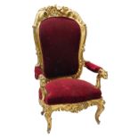 A 19thC Continental giltwood and gesso open armchair, the high back carved with scrolls, flowers, et