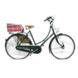 A Pashley British racing green ladies bicycle, with brook sadle and a chequered box to rear.