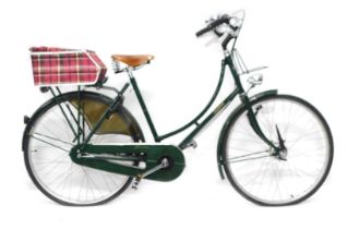 A Pashley British racing green ladies bicycle, with brook sadle and a chequered box to rear.