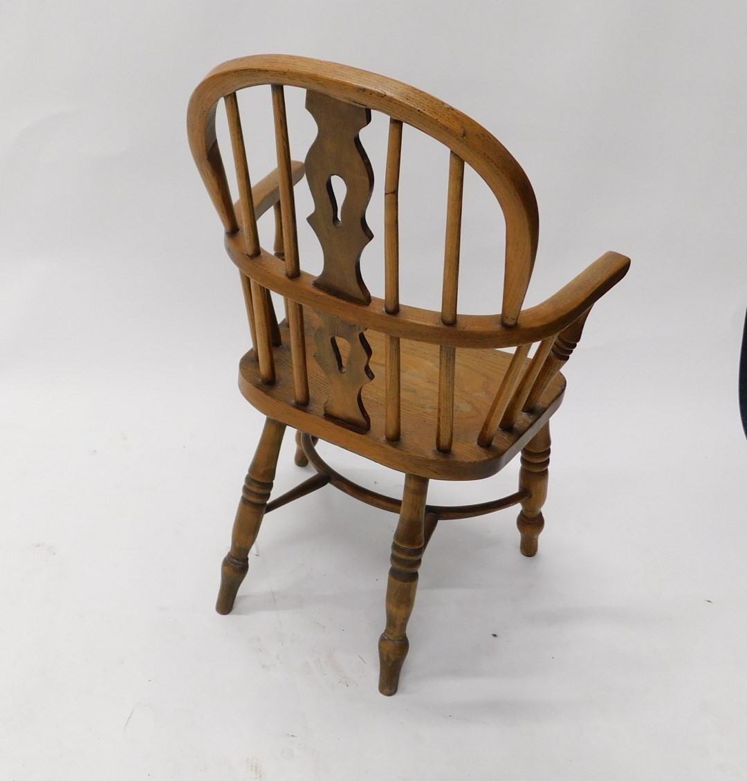 An ash and elm child's Windsor open armchair, with a pierced splat, solid seat, on turned legs, with - Image 3 of 3