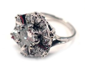 A diamond set cluster ring, in the Deco style with central round brilliant cut diamond, approx 0.71c