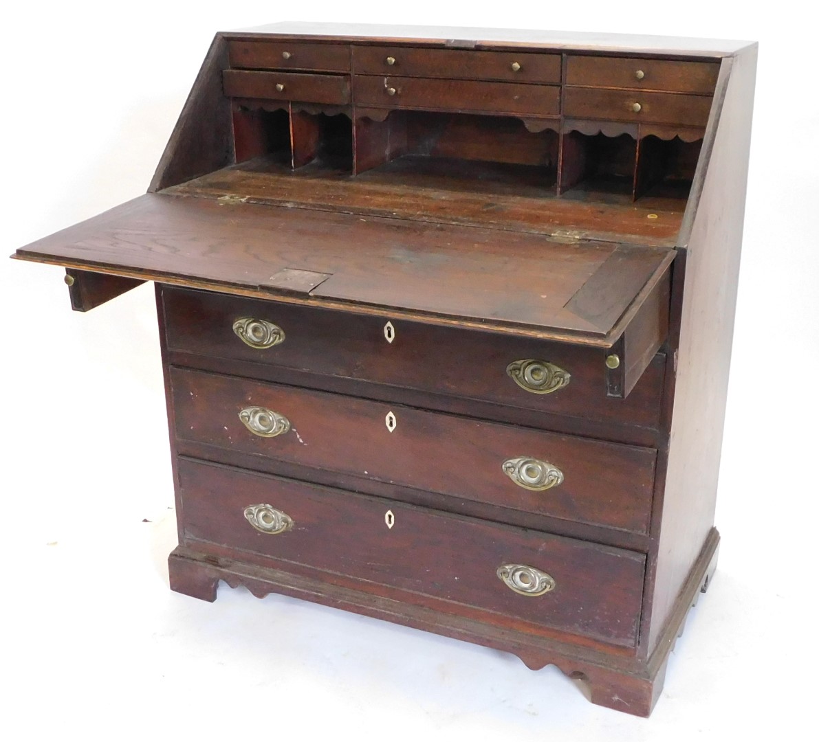 A George III oak bureau, the fall enclosing a fitted interior above four graduated drawers with oval - Image 2 of 3