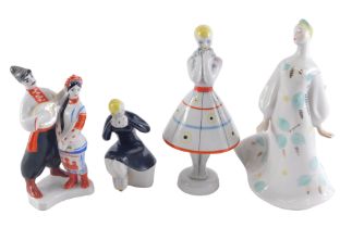 Four Russian porcelain figures, comprising girl in black skater dress on perch, stamped USSR, 13cm h